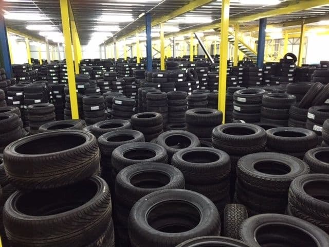 Stacks of part worn tyres in a tyre warehouse